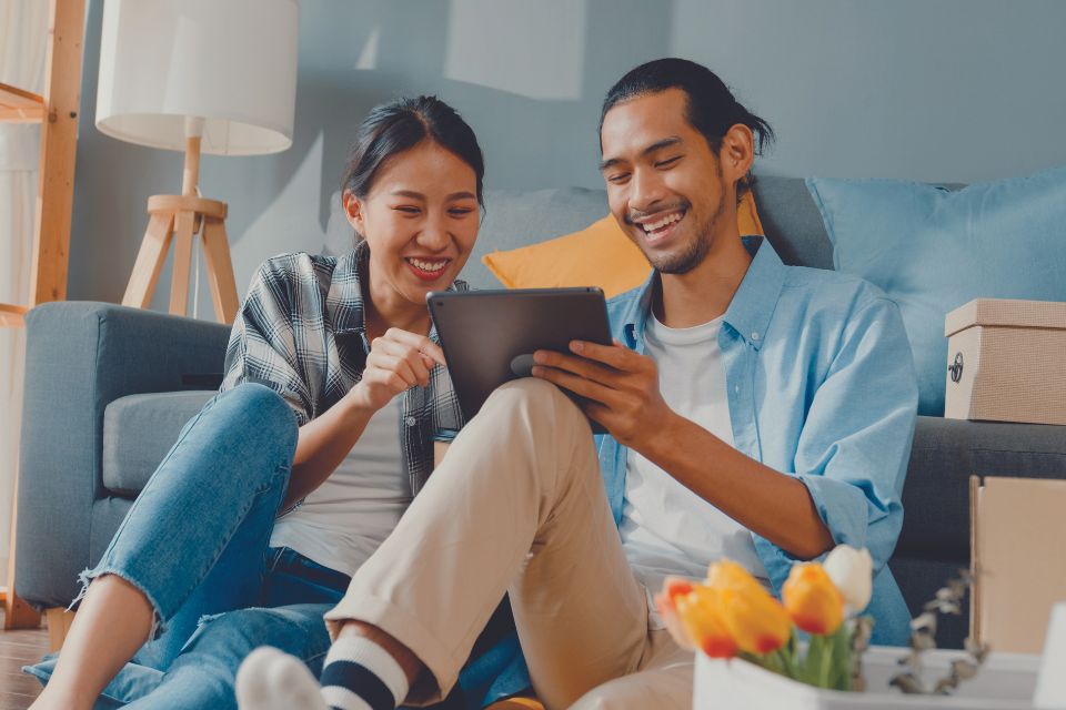 Husband and Wife planning home renovation on tablet